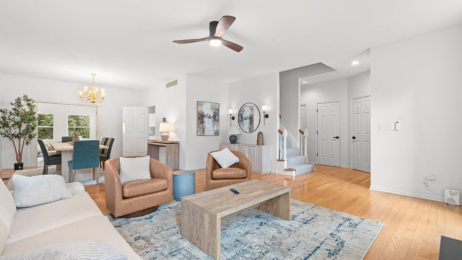 Inviting main living room with a cozy fireplace, comfortable furnishings, and large windows.