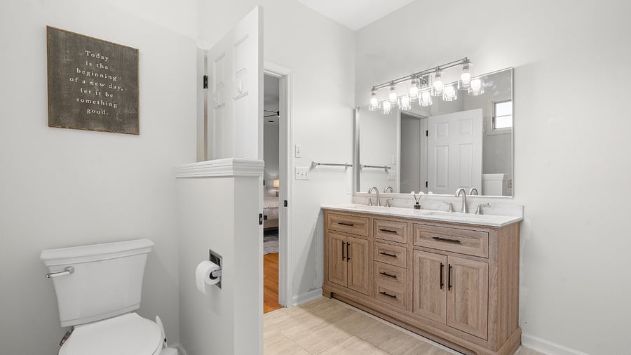 Private primary ensuite bathroom with a double vanity, separate shower, and relaxing Jacuzzi tub.