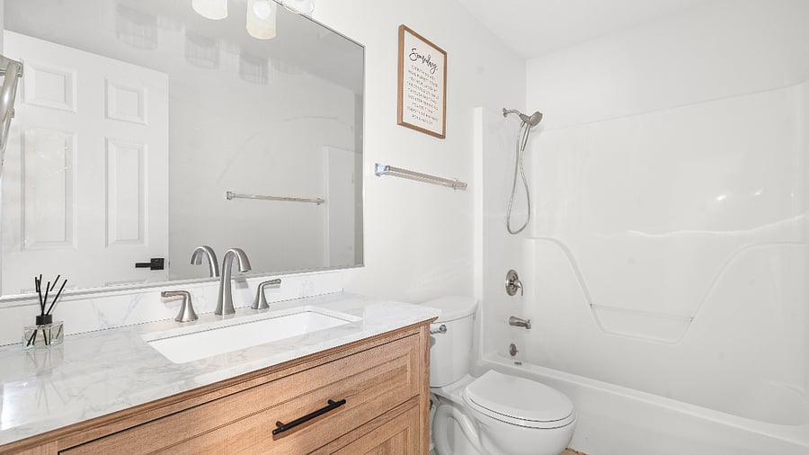 Upper-level shared bathroom with a full tub and shower.