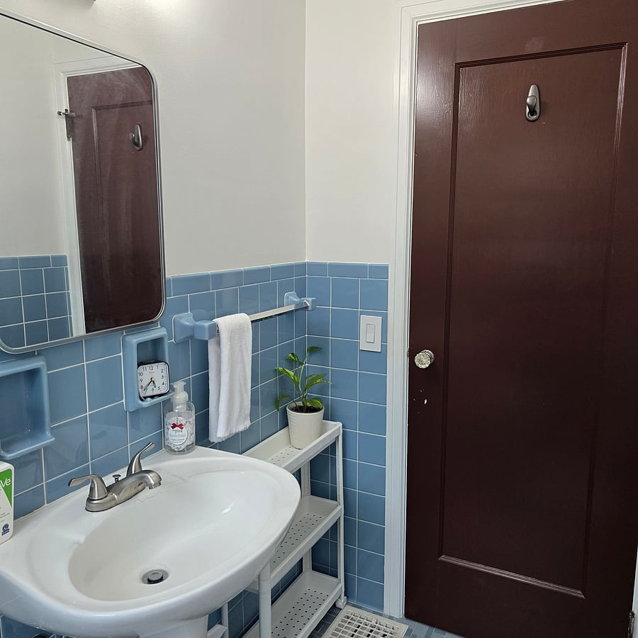 Bath has storage shelving unit for your personal hygiene products.