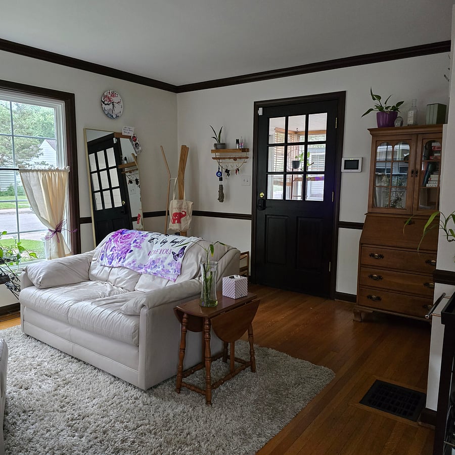 Front door leads to the sunroom. And the entry has a full length mirror, a coat stand and key holder.