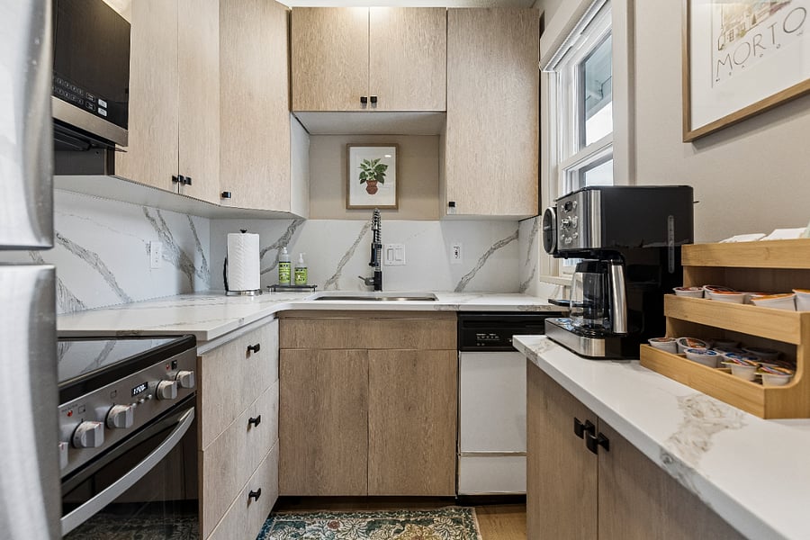 The fully renovated kitchen is thoughtfully equipped with everything you need to prepare meals, from cookware and utensils to a Cuisinart Coffee Center 2-in-1 Coffee Maker, electric kettle, and a starter kit of complimentary coffee and tea.
