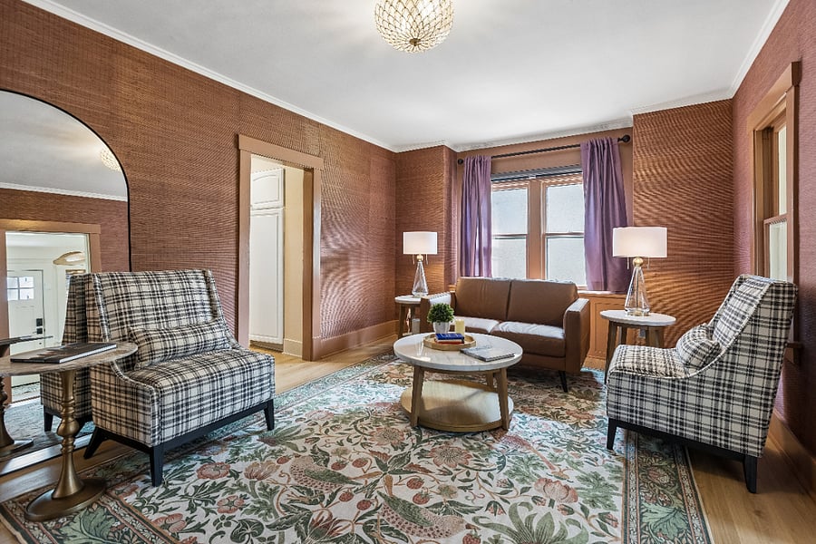 Gather in the thoughtfully designed living room, where rich textures and comfortable seating create the perfect place to relax.