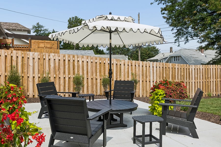 Relax on the private patio with Polywood seating, a charming scalloped umbrella for shade, and a fully fenced backyardperfect for enjoying Omaha's beautiful weather.