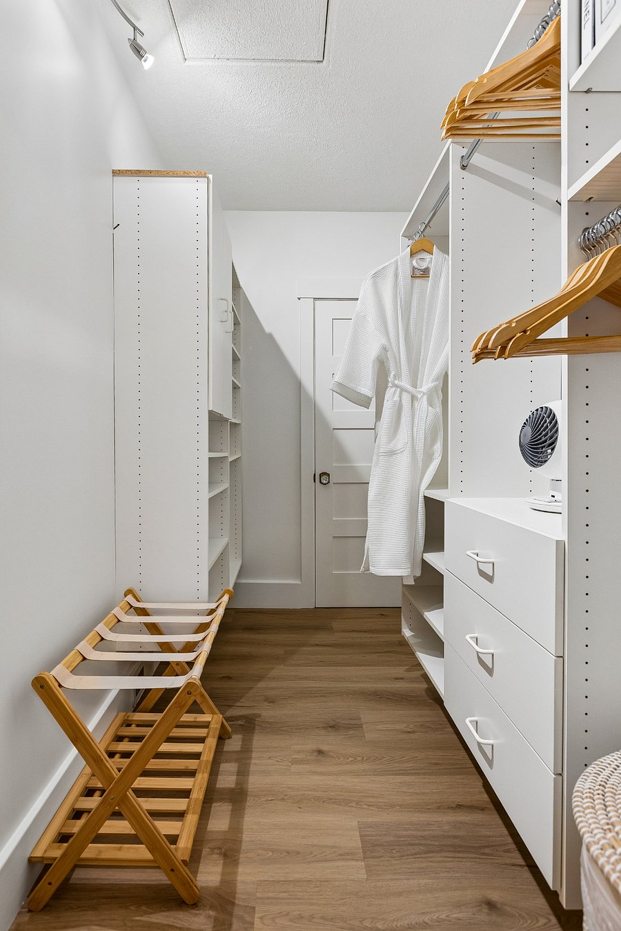 The spacious walk-in dressing room offers generous shelving, drawers, hanging space, luggage racks, and waffle robesmaking it easy to unpack and settle in, whether you're staying for a weekend or an extended visit.