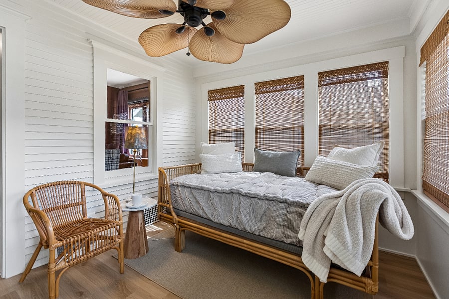 Enjoy your morning coffee or curl up with a book in the light-filled four-season sunroom, featuring a comfortable twin daybed for lounging and relaxing.