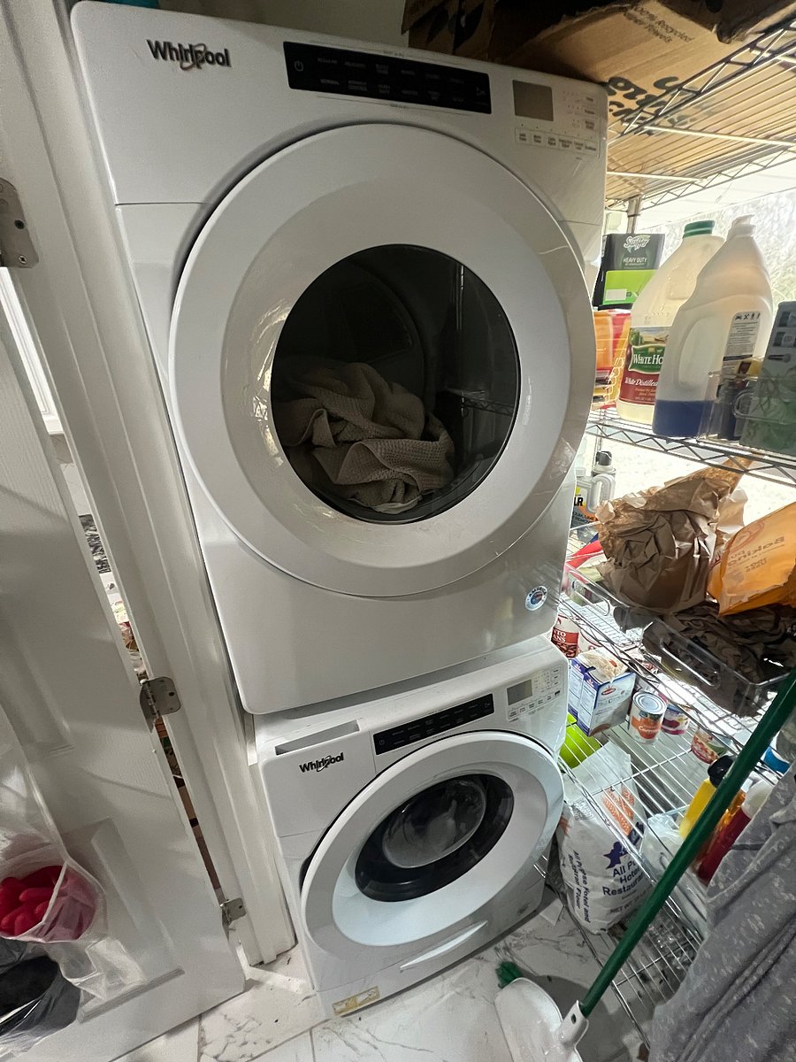 the laundry room has front-loading washer/dryer, cleaning supplies & basic maintenance tools
