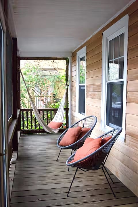 Screened-in porch with hammock chairs for reading and relaxing.