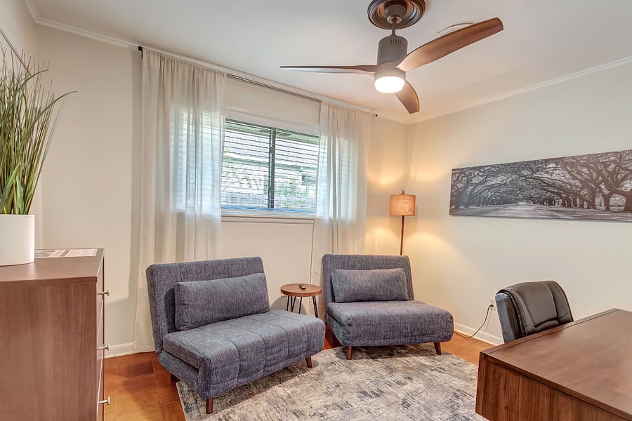 Third bedroom / office includes desk, tv and two chairs that convert into twin beds.  