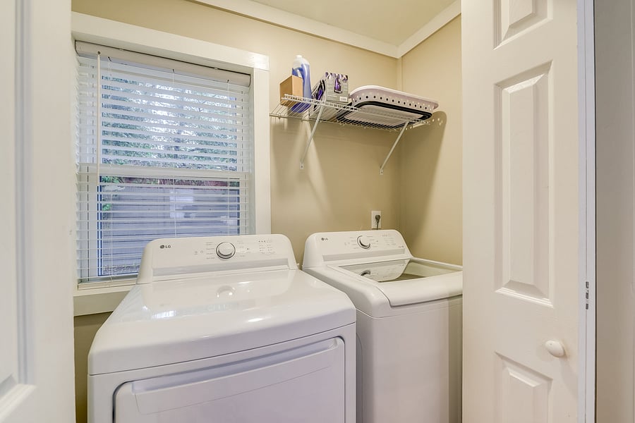 Fully equipped laundry space with washer, dryer, and essentials