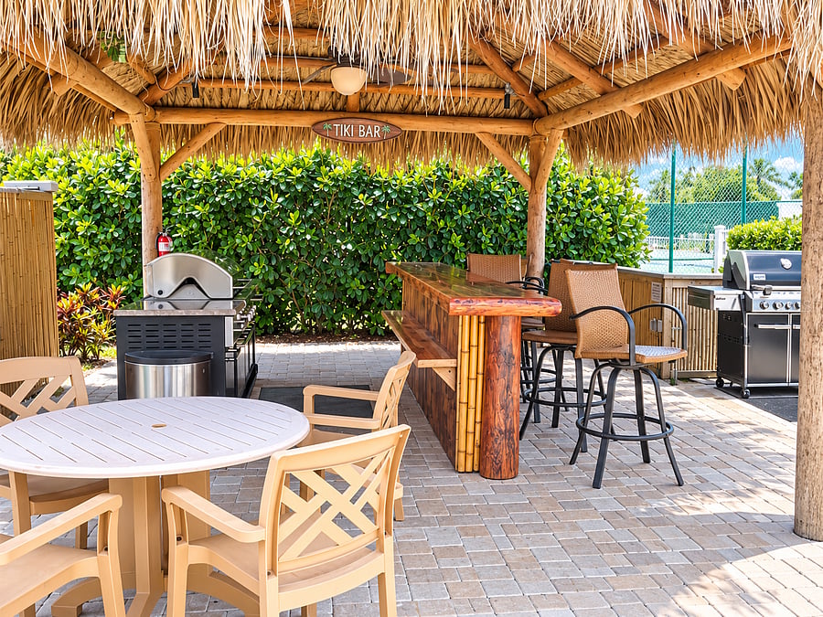 The community tiki area offers shaded seating and grills for casual outdoor meals and gatherings.