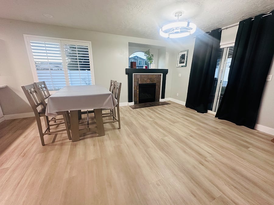 Spacious shared dining area with fireplace and direct access to the covered backyard patio.