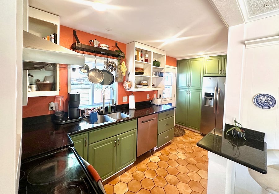 Fully stocked kitchen, back door to the patio/yard