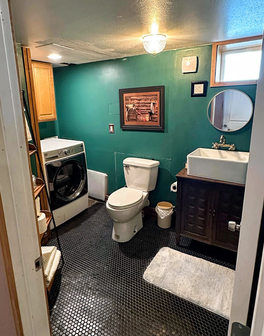 Basement laundry room and half-bath, with washer/dryer combo unit