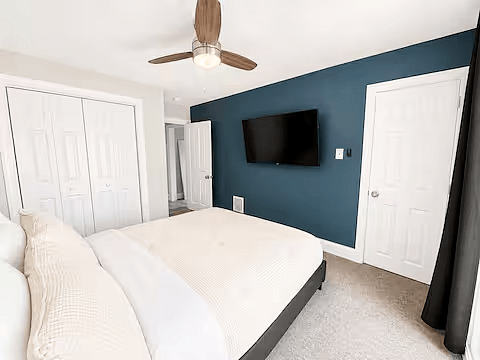 Queen bedroom with Smart TV and ample closet space