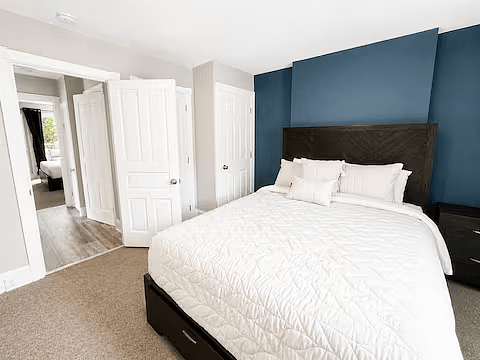 Comfortable queen bedroom with dresser and storage