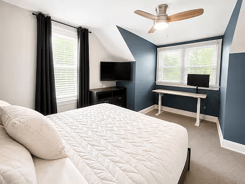 Queen bedroom with dedicated workspace and Smart TV