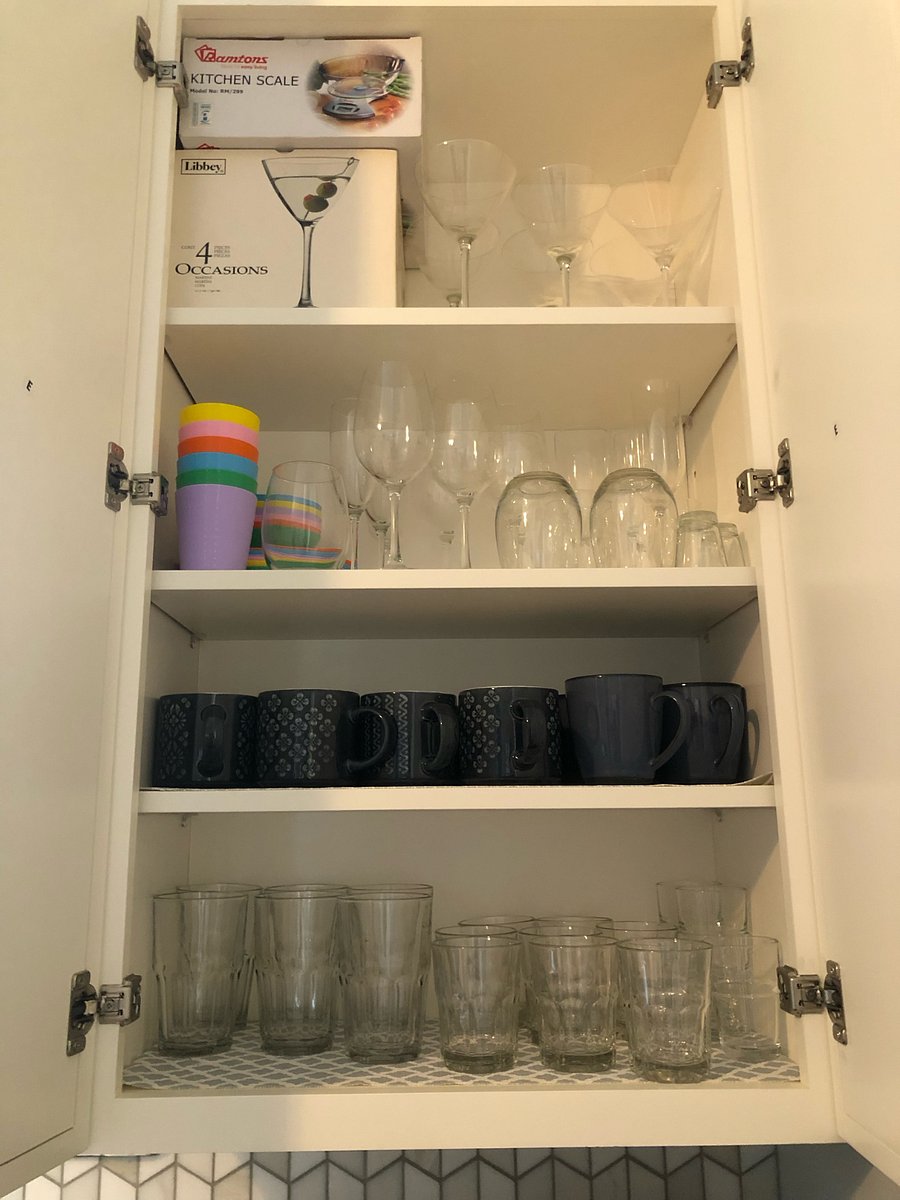 Variety of glasses and mugs, as well as plenty of cabinet space for your groceries.