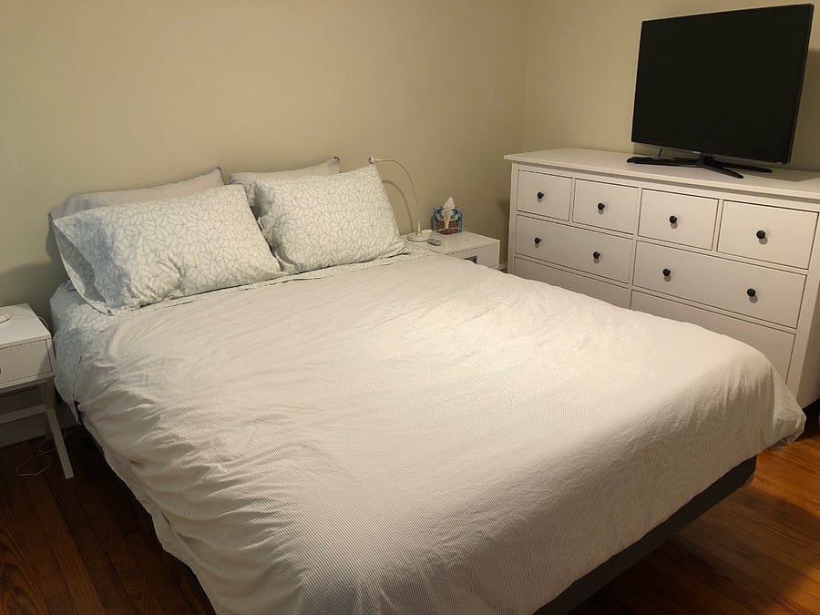 Middle bedroom has queen size bed, ceiling fan, 2 bedside tables, TV and large dresser