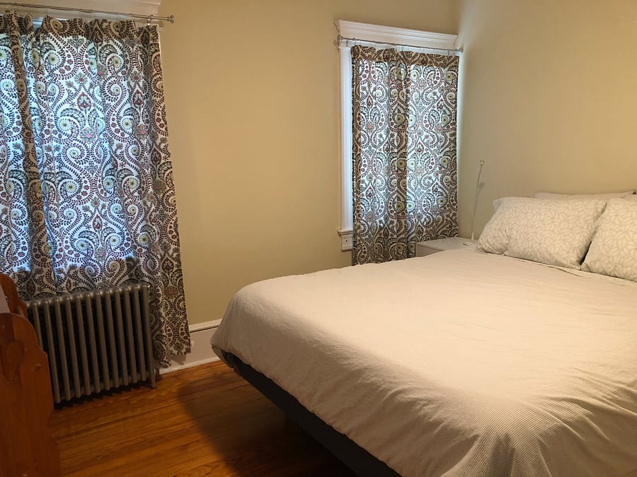 Middle bedroom has queen size bed, ceiling fan, 2 bedside tables, TV and large dresser
