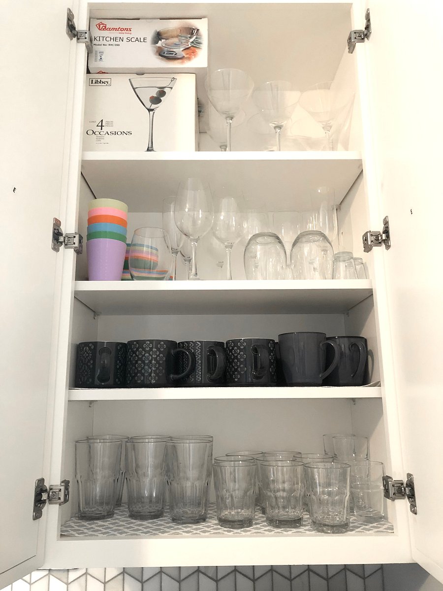 Variety of glasses and mugs, as well as plenty of cabinet space for your groceries.