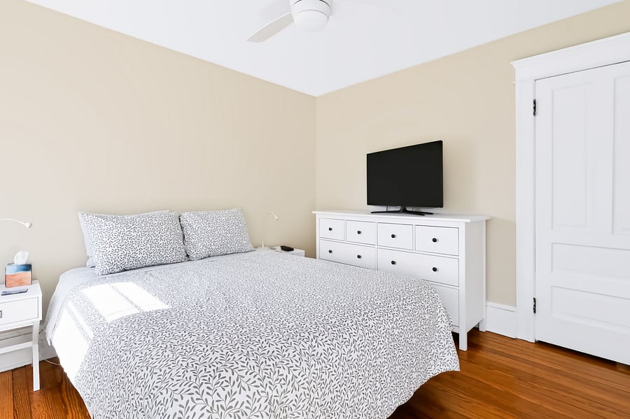 Middle bedroom has QUEEN size bed, ceiling fan, 2 bedside tables, TV, large dresser, full length mirror
