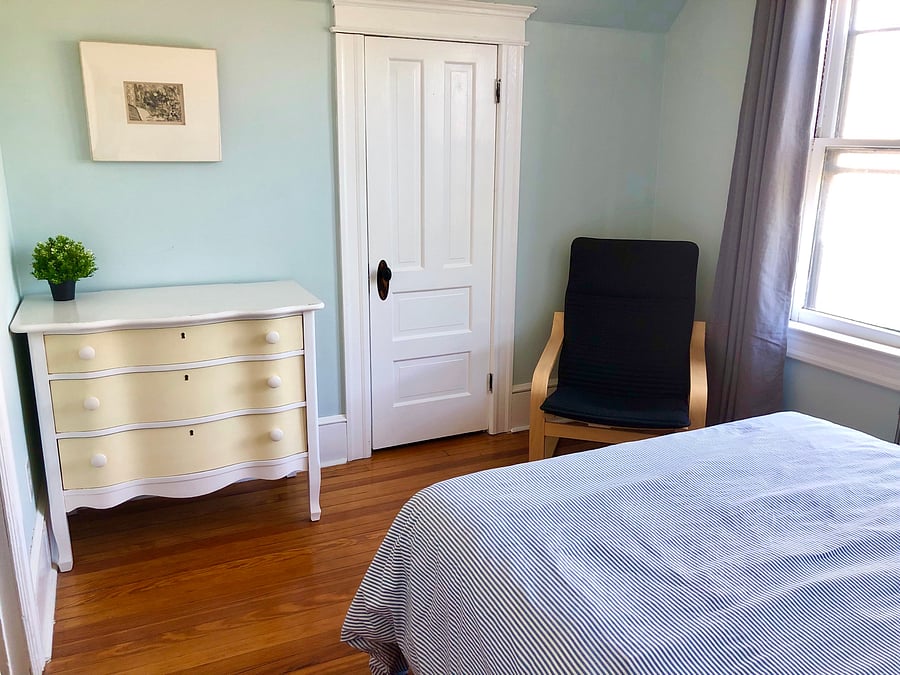 Back bedroom has FULL size bed, ceiling fan, 2 bedside tables, black out curtains, Ikea Poang easy chair and vintage dresser.