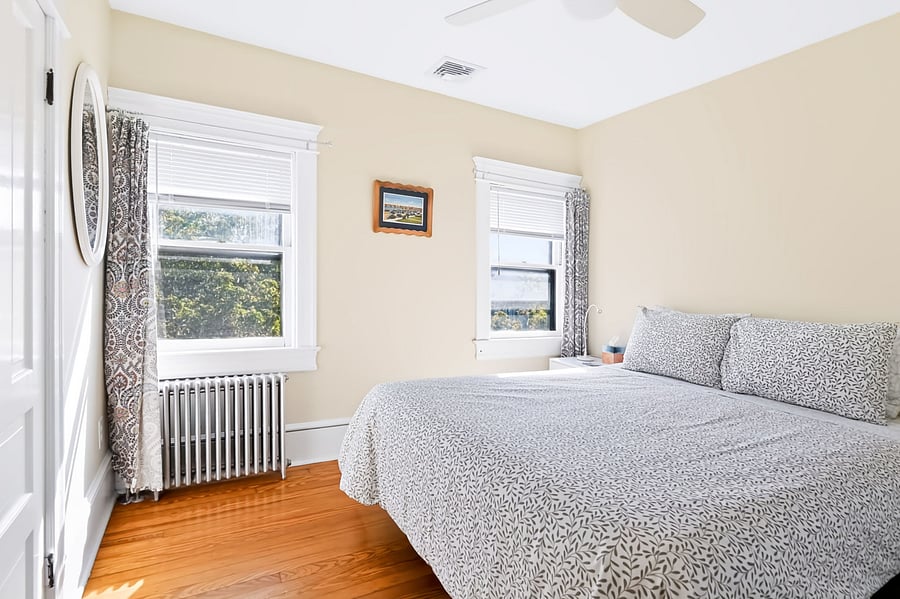 Middle bedroom has QUEEN size bed, ceiling fan, 2 bedside tables, TV, large dresser, full length mirror (added after photo was taken)