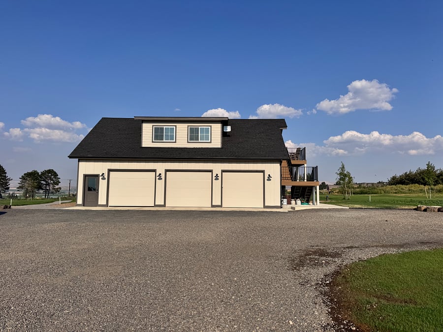 Guesthouse is above garage with parking to the right.