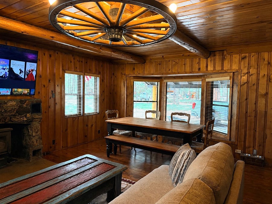 Living room facing bay windows into dining area