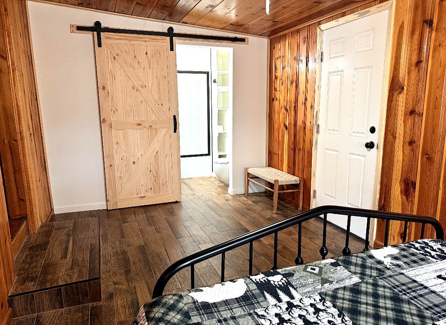 Bedroom #2 looking at bathroom #2 with a barn door