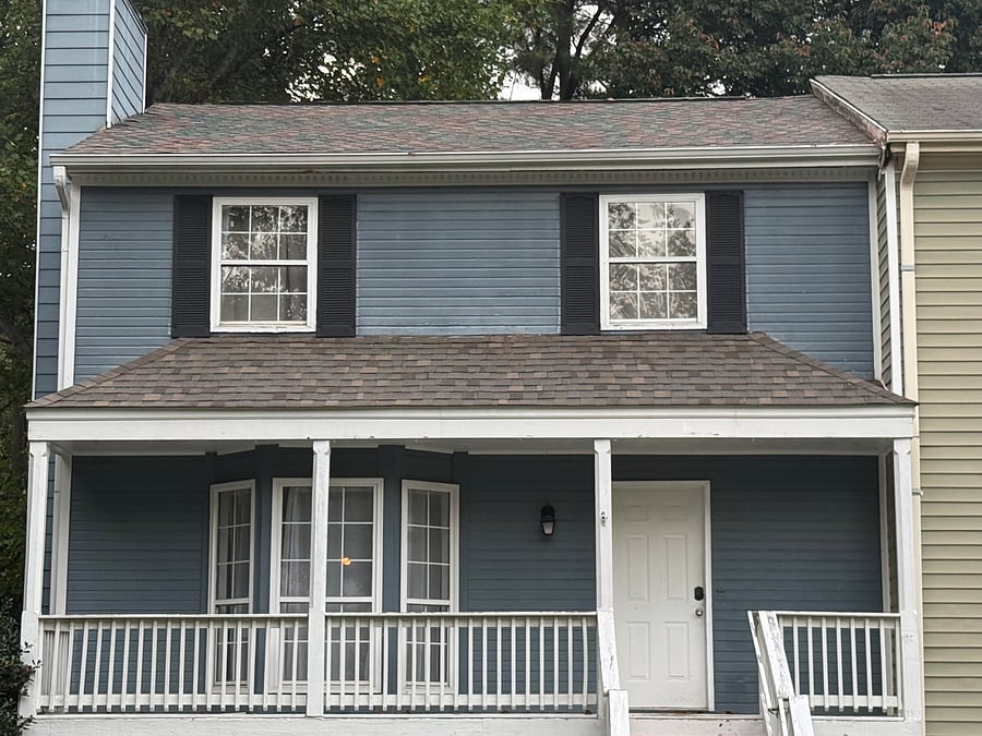 Front of house. There are stairs that lead to the front door.