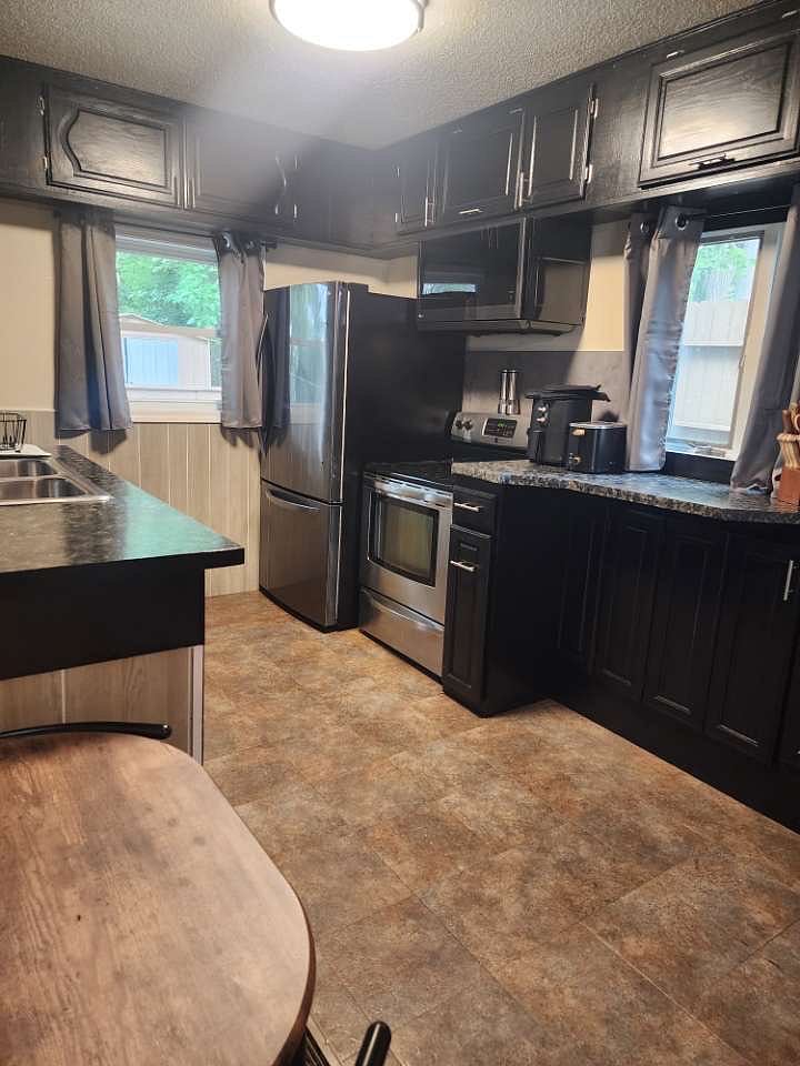 Kitchen: pots, pans, crockpot, dishes, cups, utensils