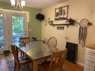 stainless steel pottery barn table next to french doors leading out side deck