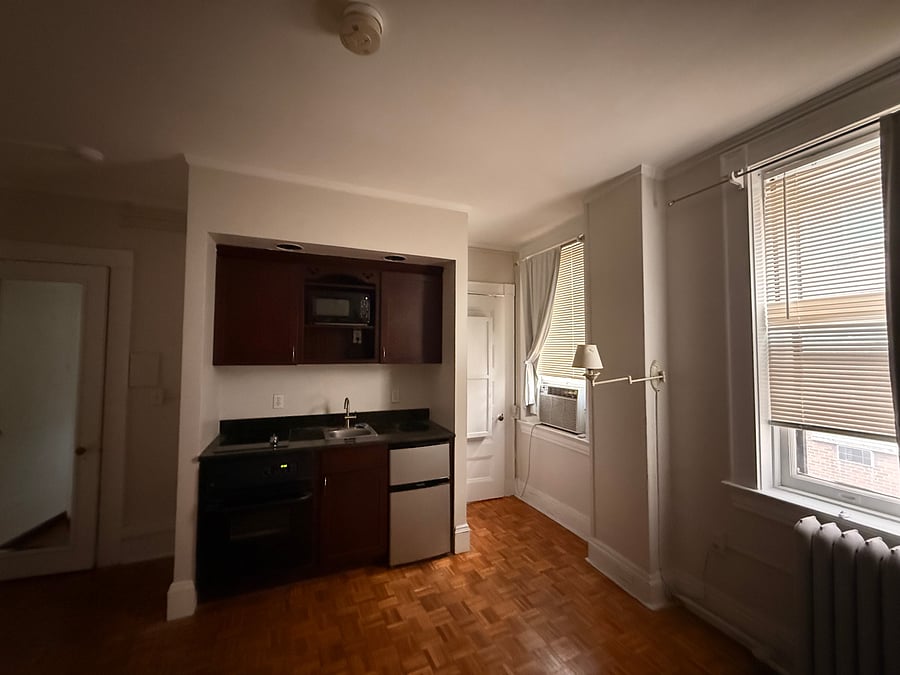 Kitchenette with stove top, oven, mini fridge and freezer, and microwave. 