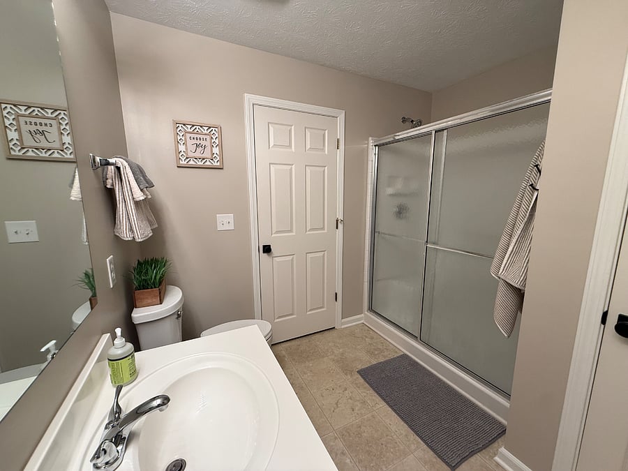 Large en-suite bathroom with walk-in shower, double vanities and complimentary starter toiletries. 