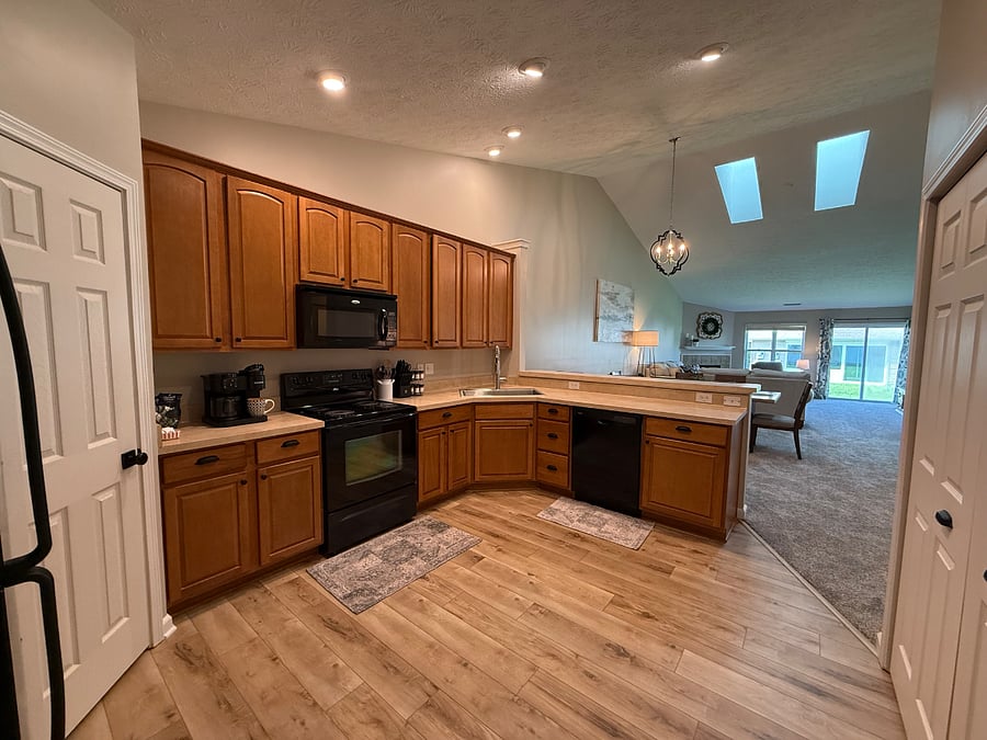 Spacious kitchen with vaulted ceilings and skylights. 