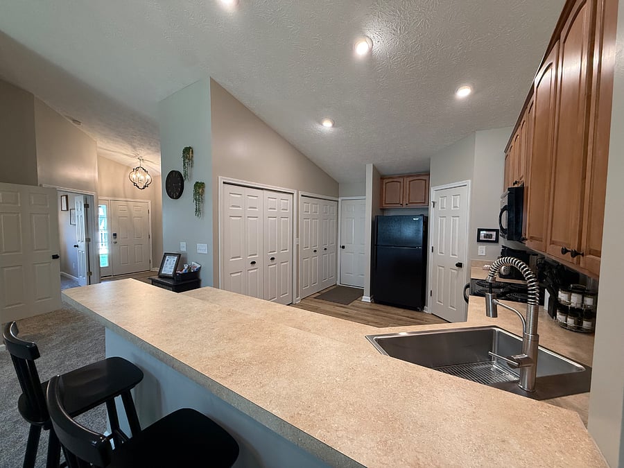 View of the kitchen, entry and door to the two car garage. 
