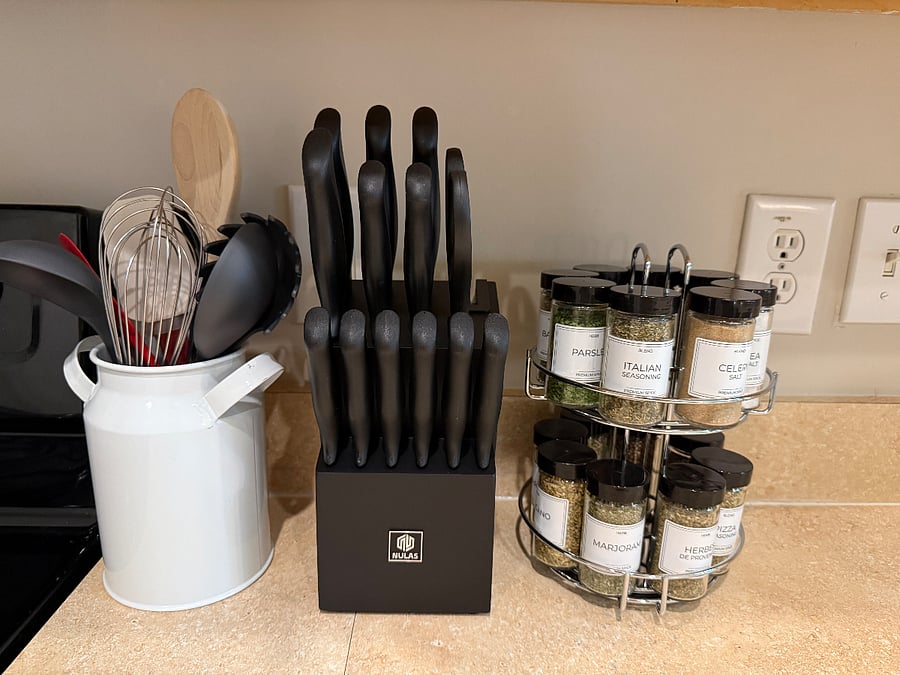 Cooking utensils, knife set and spices are provided.