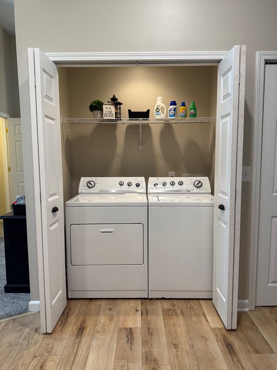 Washer and dryer area with starter detergents included. 