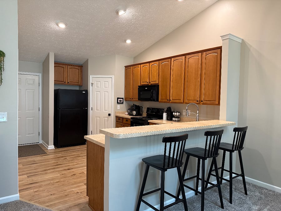 Large open concept kitchen with barstools. 