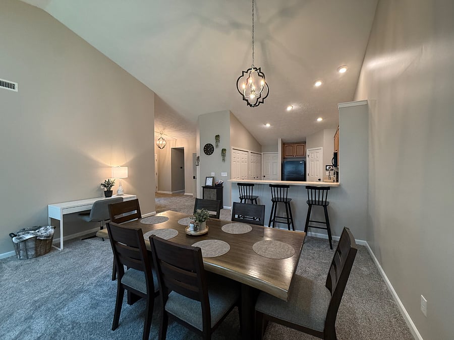 View of dining area, kitchen and entry. 