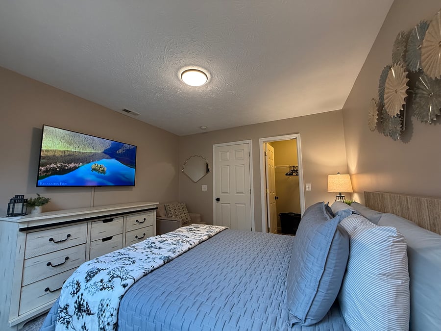 Queen bedroom with walk-in closet and 55' Roku TV. 