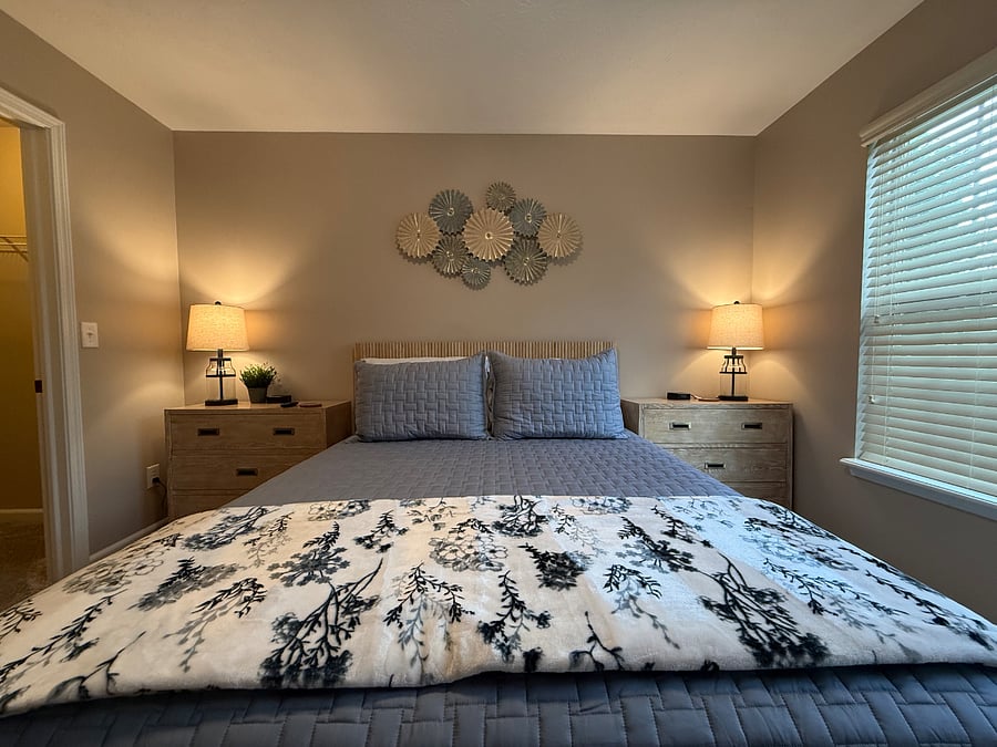 Queen bed with nightstands and lamps. 