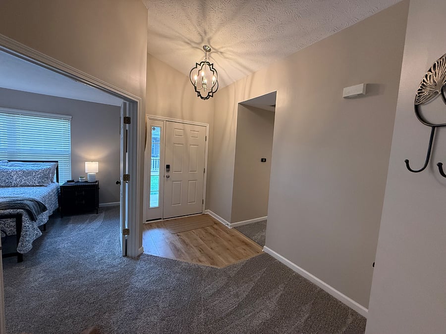 Entry of home and full bedroom to the left. 