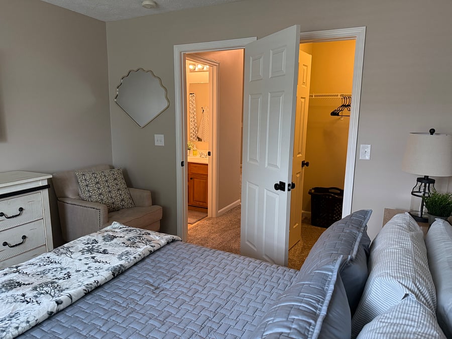Queen bedroom with view of walk-in closet and bathroom in view. 