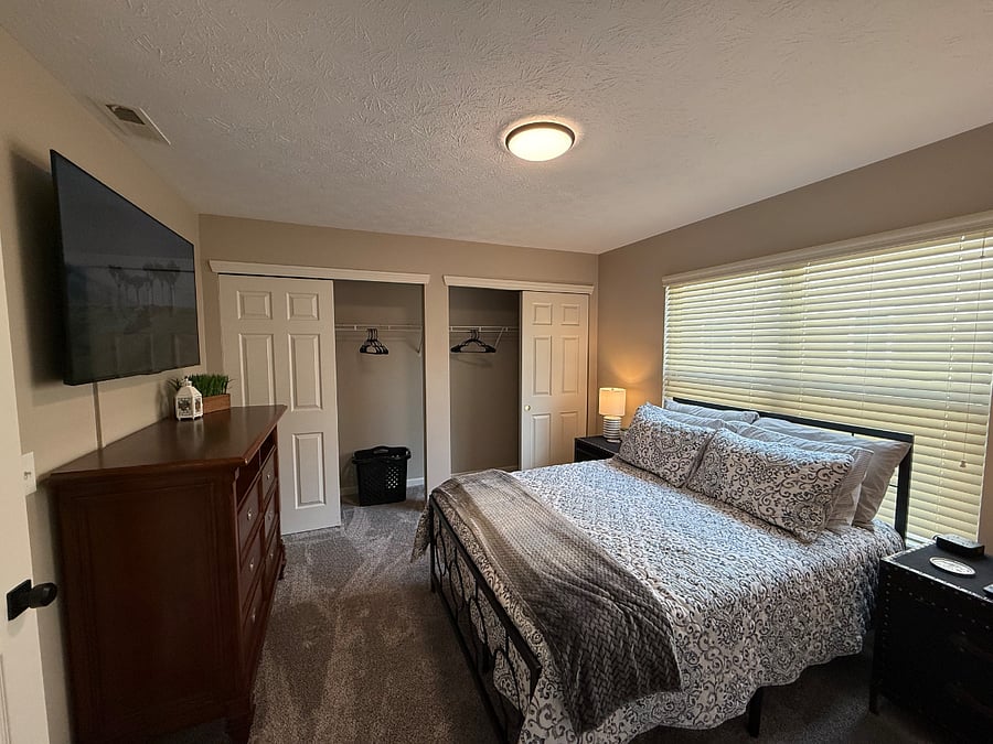 Comfortable bedroom with 55" TV and full size bed. 