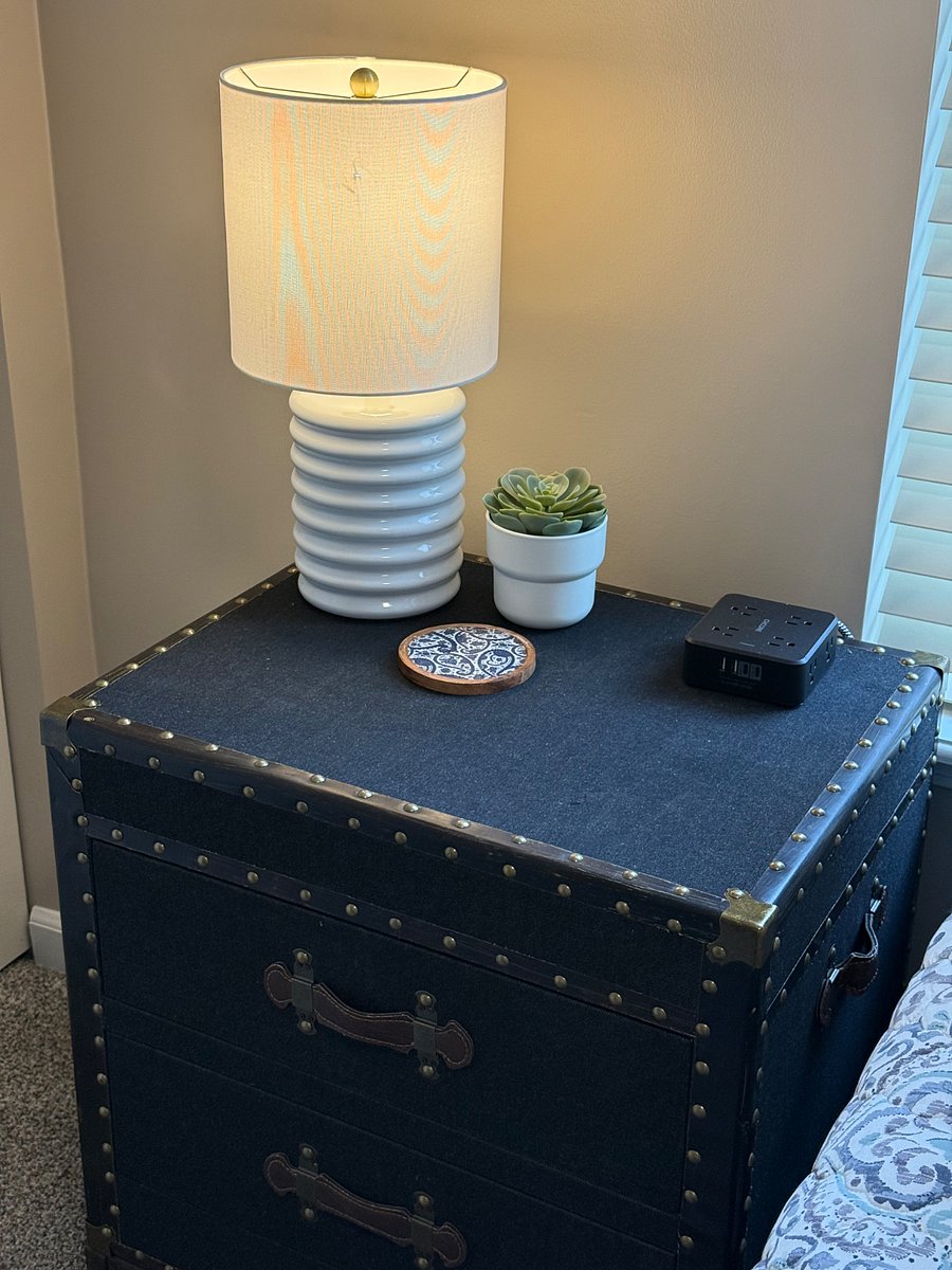 Nightstand with lamp and charging port.