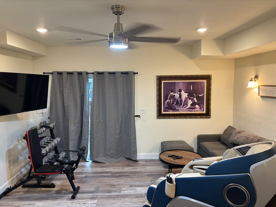 Basement living room with walkout and massage chair.
