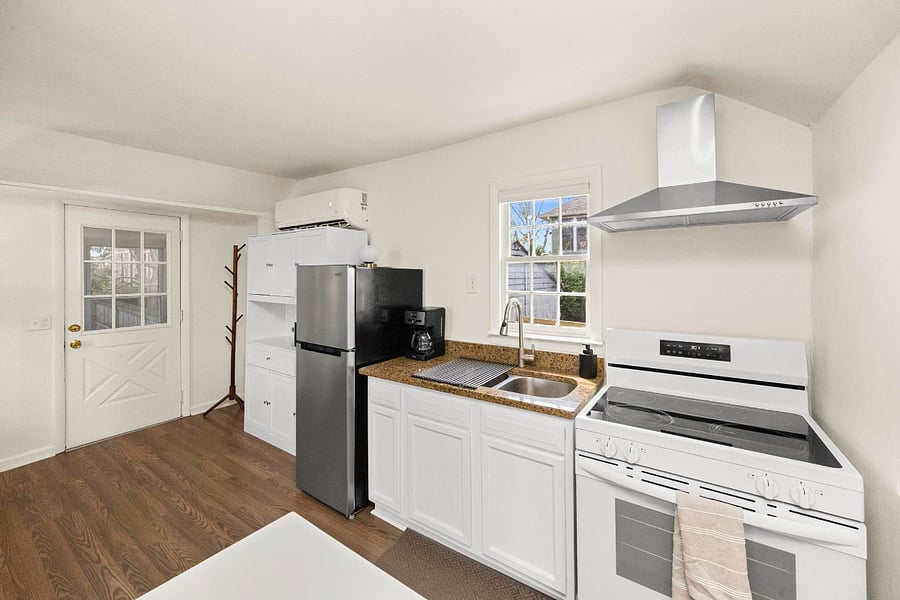 Bright countertops and a clean sink setup make cooking and clean-up feel effortless.